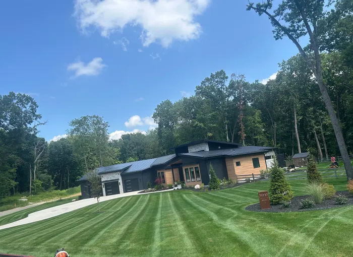 Fresh mowing stripes across a lawn in front of a modern home