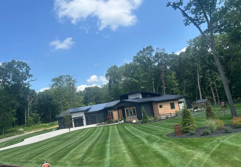 Fresh mowing stripes across a lawn in front of a modern home