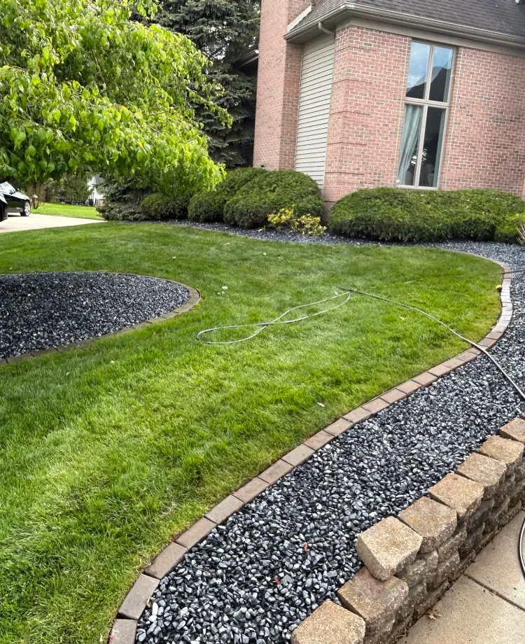 Flores landscaping with curved stone beds and carefully trimmed shrubs