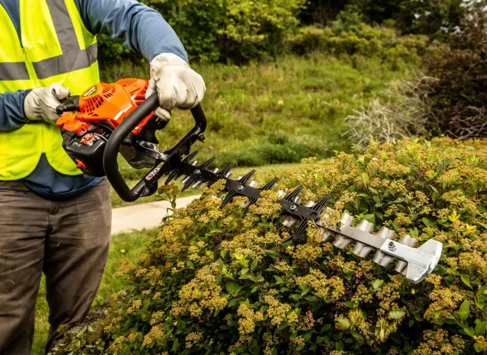 Hedge trimming with a powered trimmer